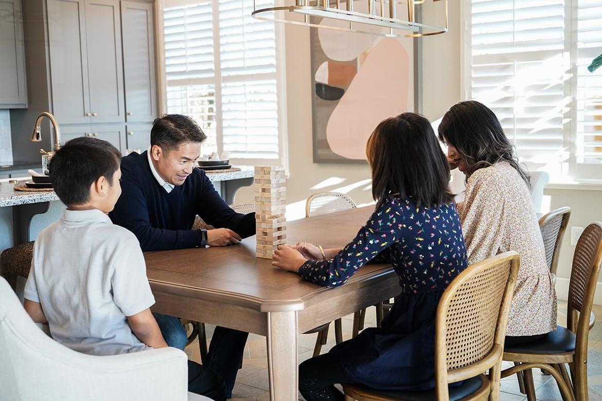 Family playing Jenga in kitchen