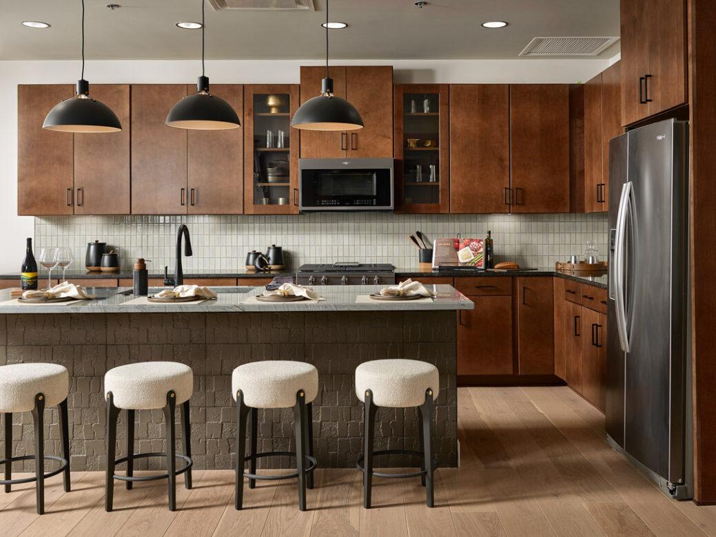 A contemporary mountain style kitchen with dark stainless appliances