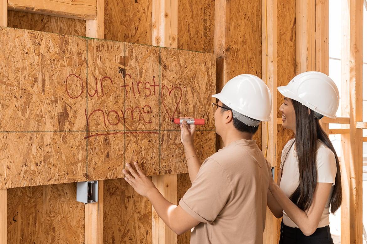 Couple visiting new home under construction