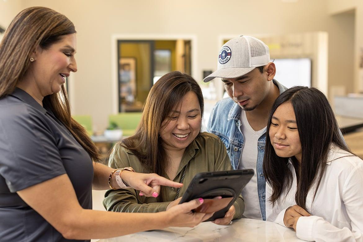 Home shoppers speaking with sales agent