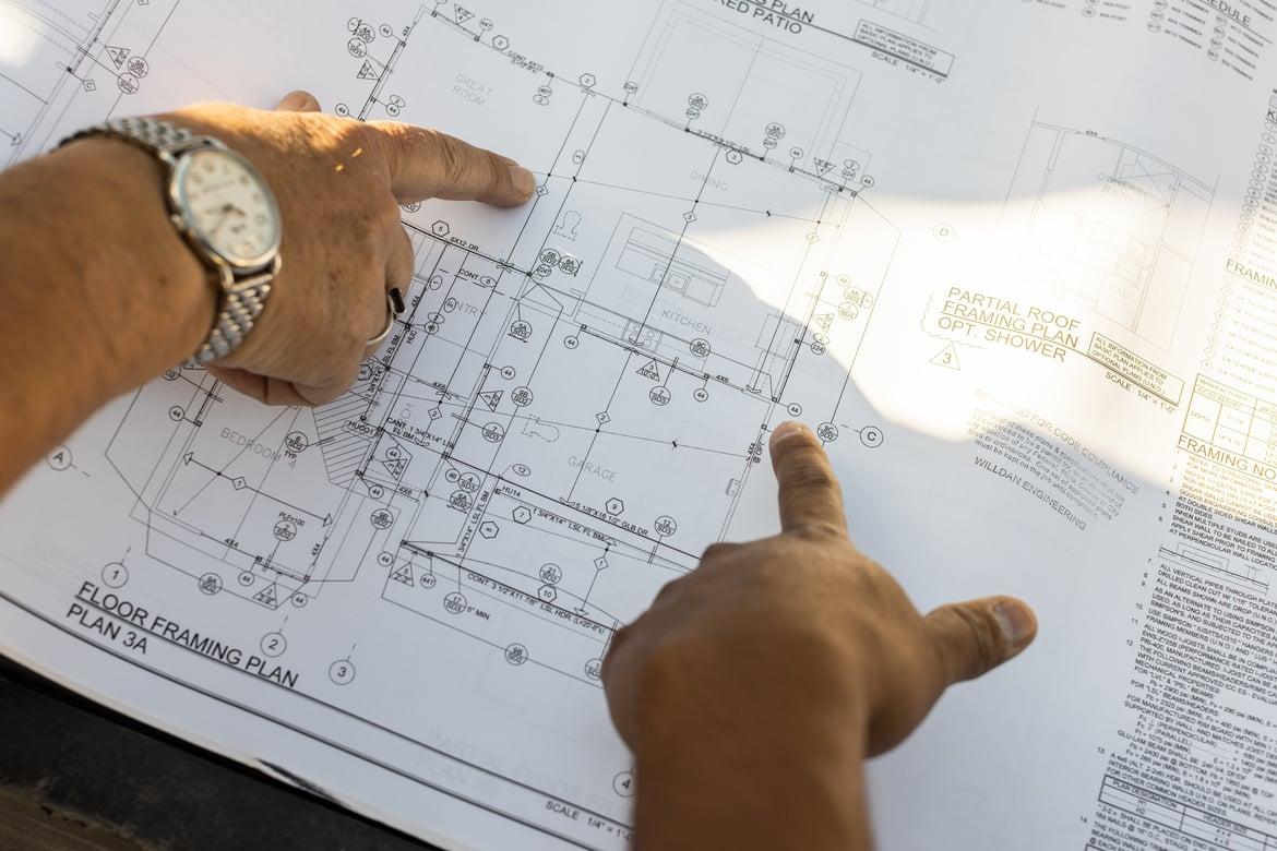 two people looking at architectural designs