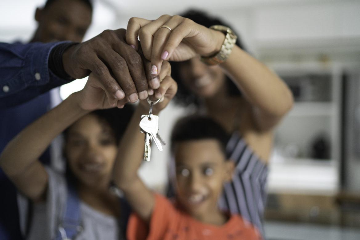 Family receiving keys to new home
